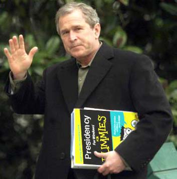 George W Bush holding funny book for retards