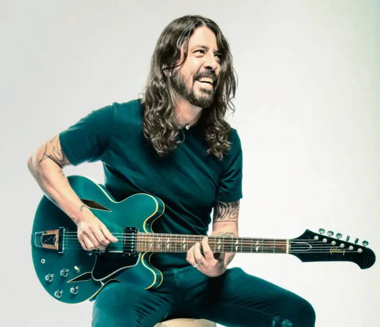 Musician Dave Grohl Holding A Guitar