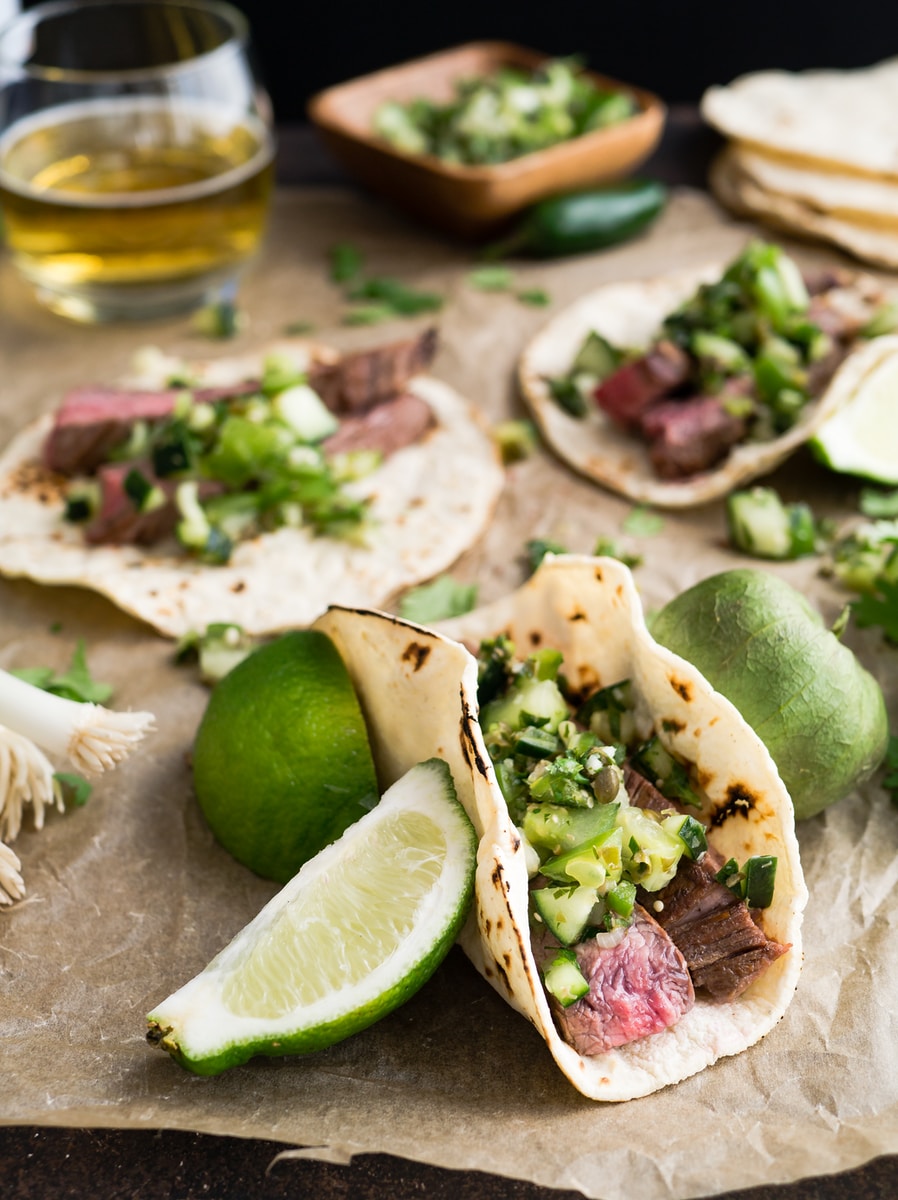 steak tacos with sliced lemons