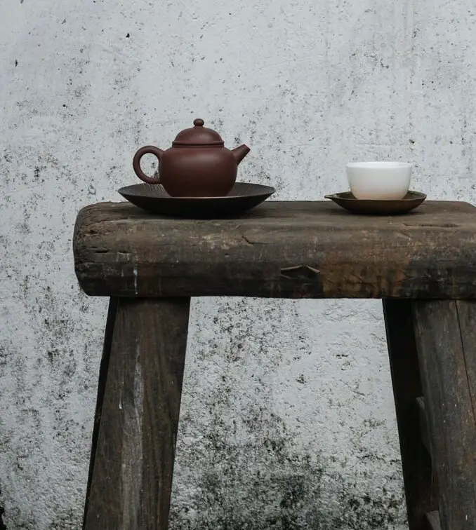 brown teapot with white cup