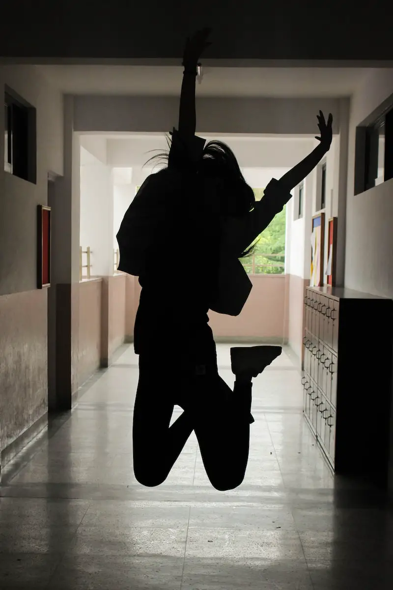 happy high school student jumping