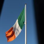 Irish Flag Fluttering In The Blue Sky