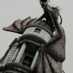 statue of dragon on gray building